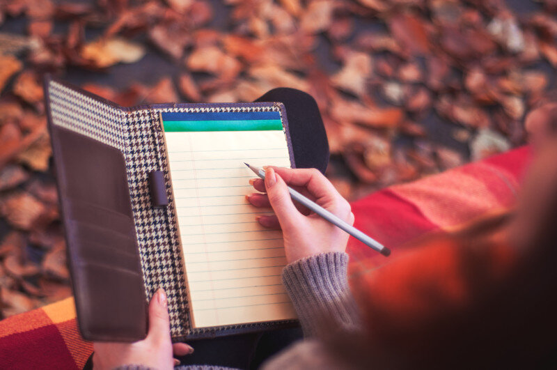 Woman writing in planner