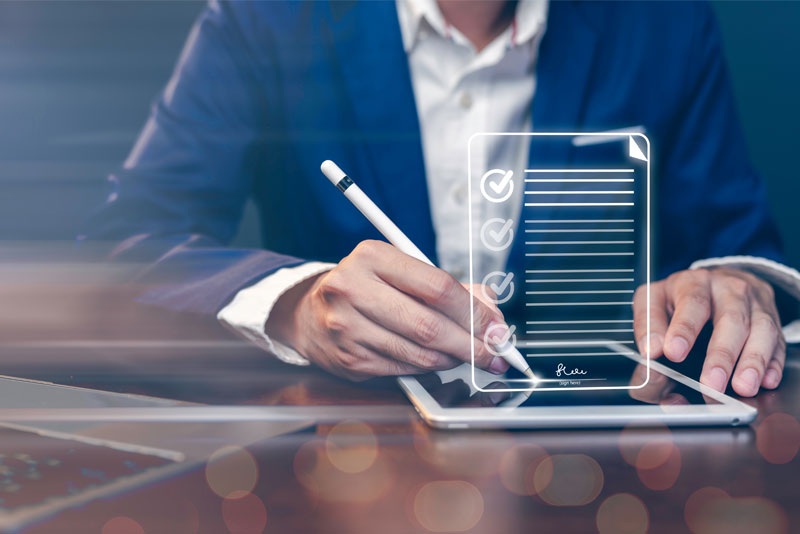 Businessman Filing Online Report via Table