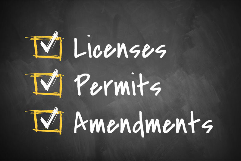 Chalkboard With Licenses Permits Amendments Written on It