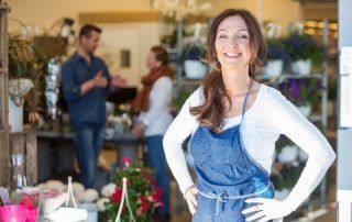 happy woman in front of storefront