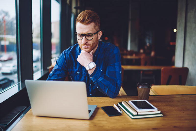 Male Freelancer Working in Coffee Shop