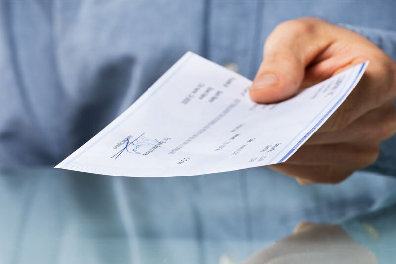 Man Holding a Paycheck