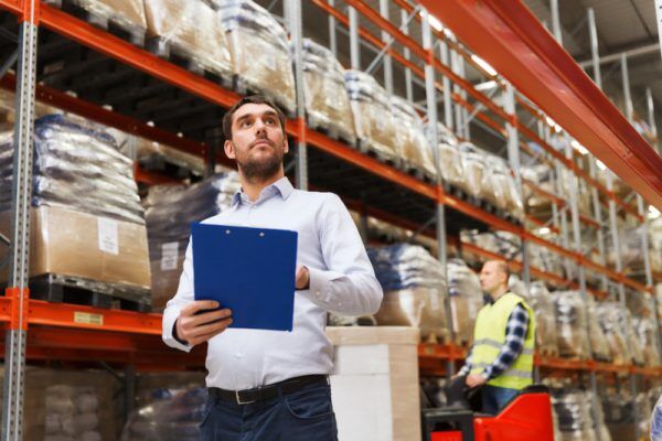 businessman with clipboard at warehouse