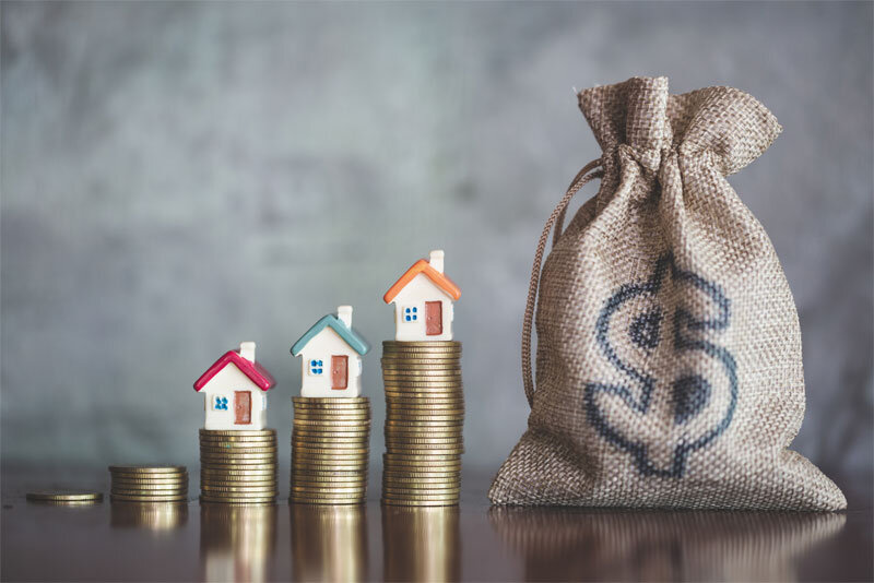 Mini Houses on Stacks of Coins