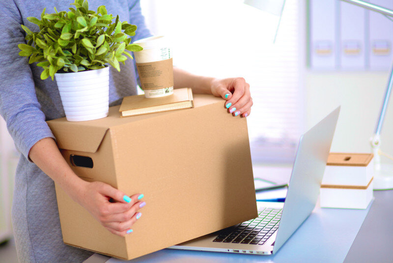 Business woman moving packing boxes