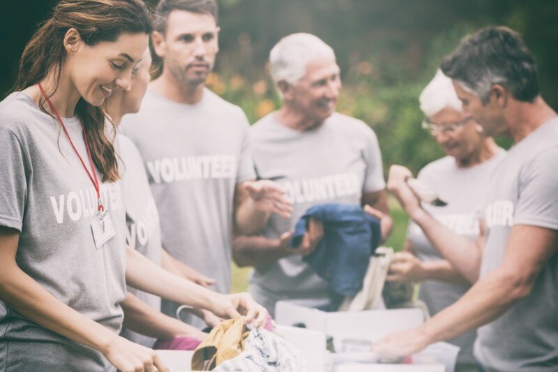 Happy volunteer looking at donation box