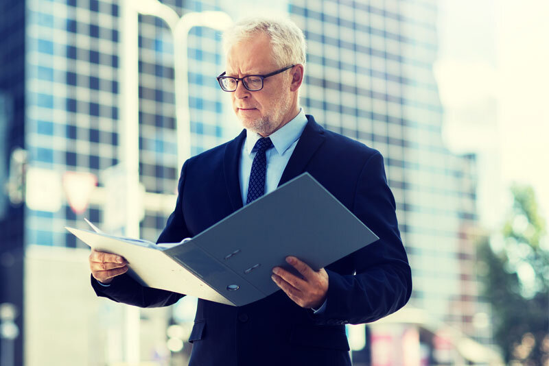 Older Businessman Reading Document