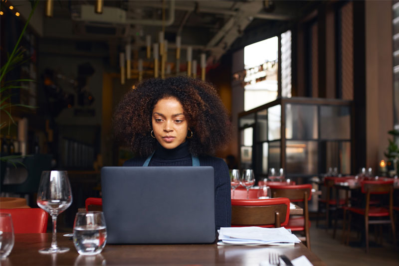 Restaurant Owner Working on Laptop