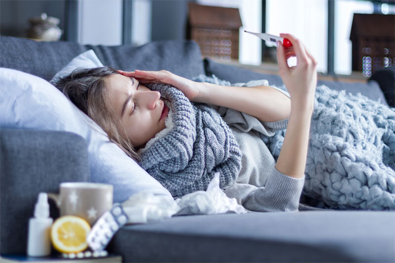 Sick Woman Laying on Couch