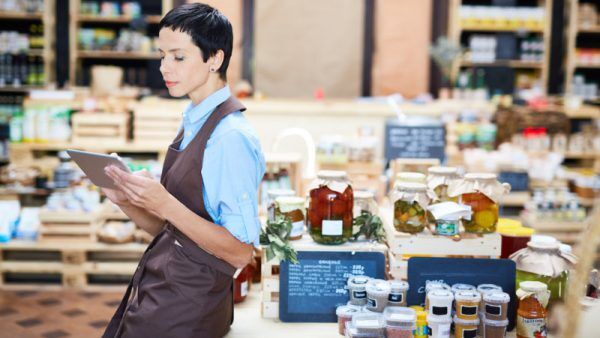 Confident Shop Assistant Focused on Work