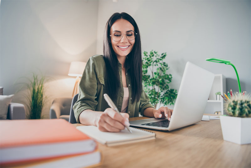 Woman Working at Desk on Computer