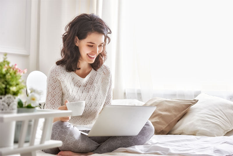 Woman Working on Laptop at Home