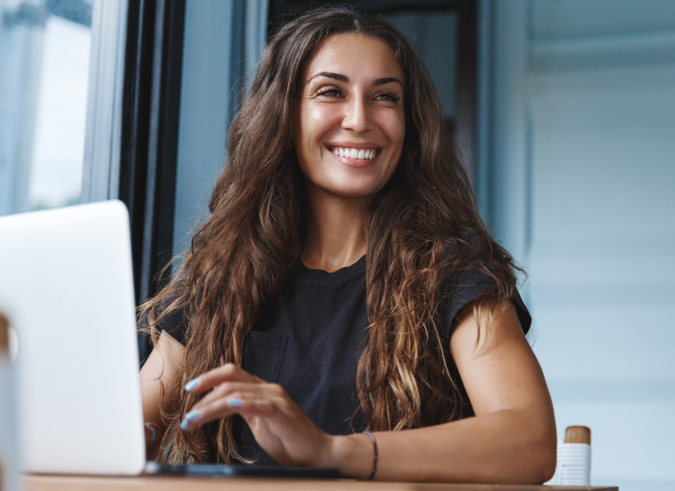 Smiling Woman Working on Her Computer